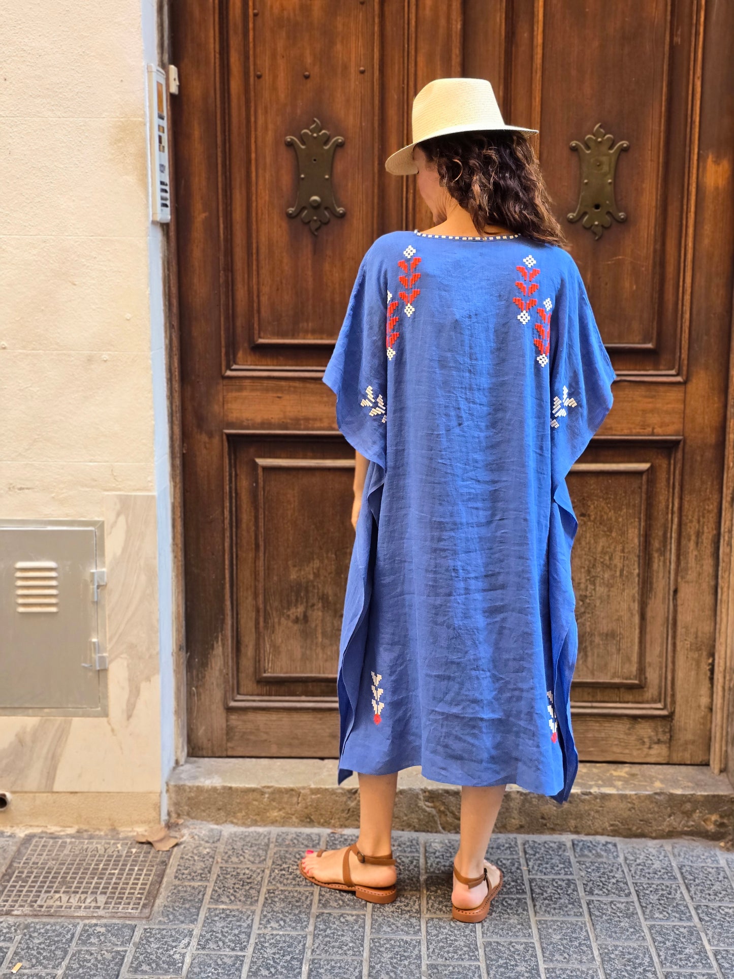 blue dress with white and red embroidery