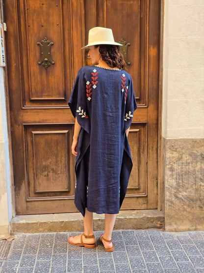 blue dress with white and red embroidery