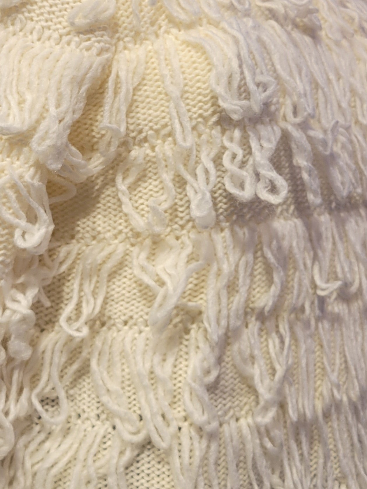 white fringed sweater