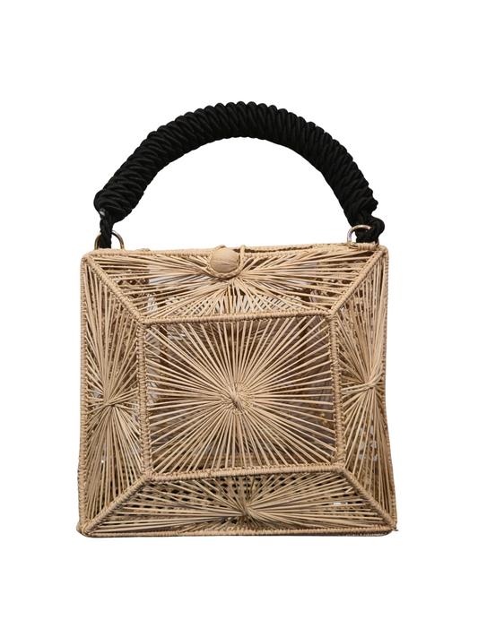Handwoven iraca cube bag with sculptural sunburst weave. 