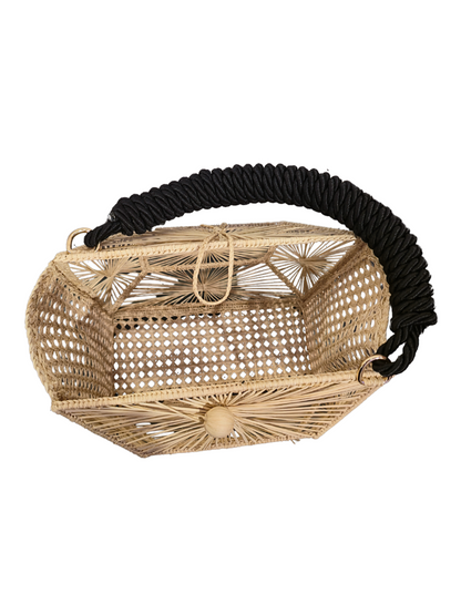 Handwoven iraca cube bag with sculptural sunburst weave. 
