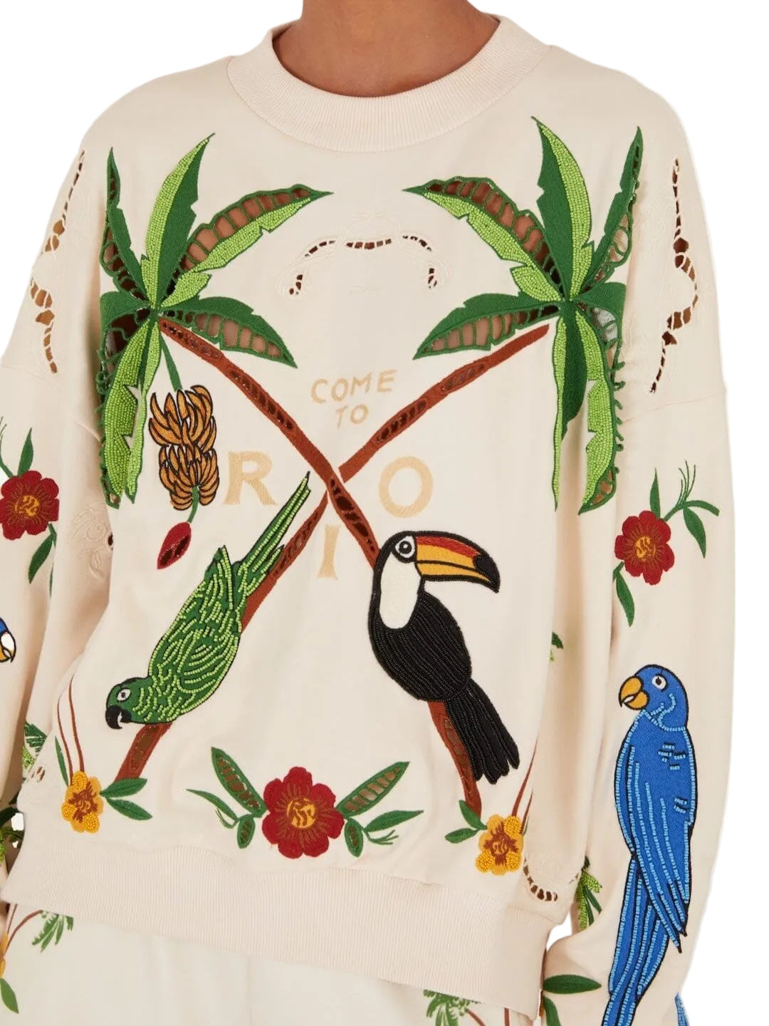 Beige sweatshirt with tropical designs including parrots, toucans, and palm trees