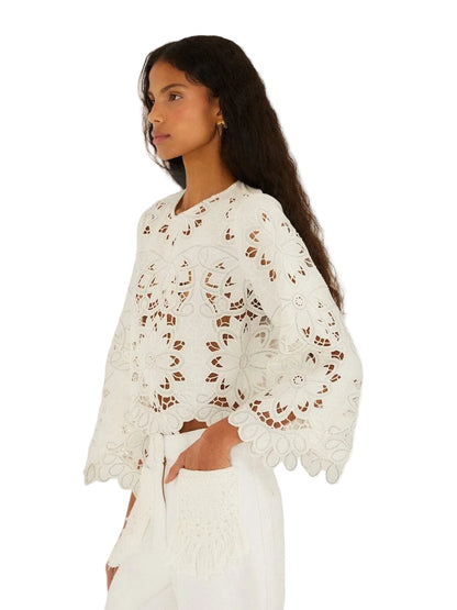 Light-colored embroidered top with floral patterns