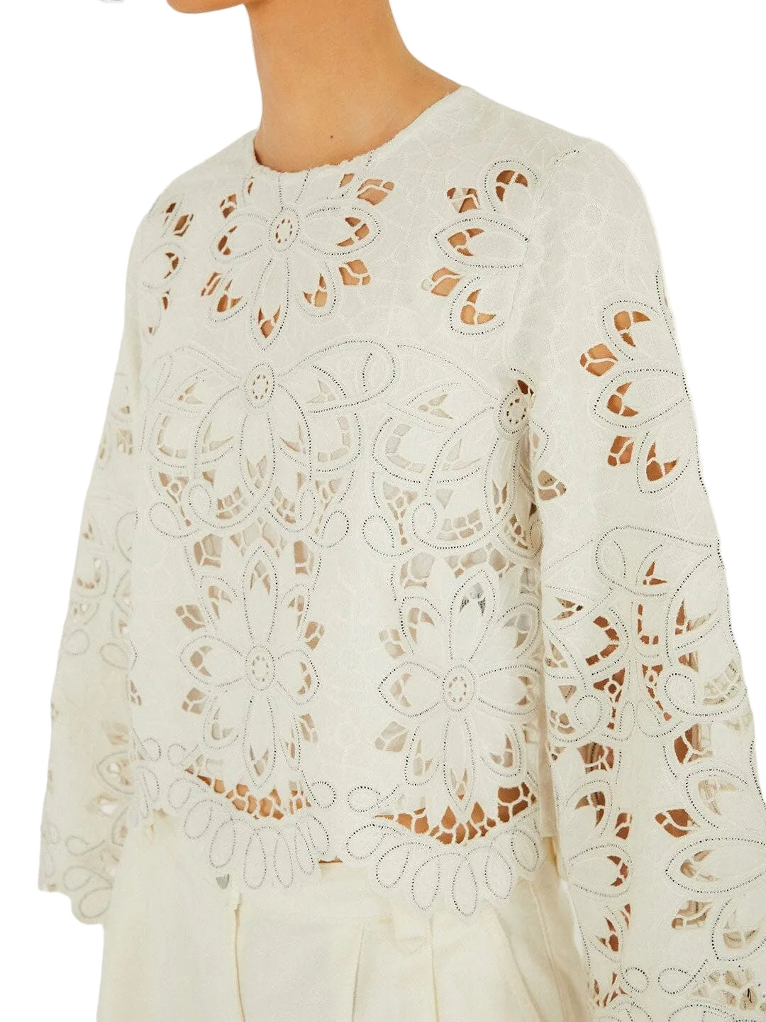 Light-colored embroidered top with floral patterns