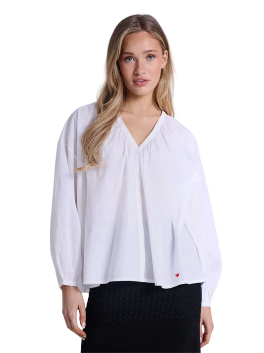 white blouse with a small red heart