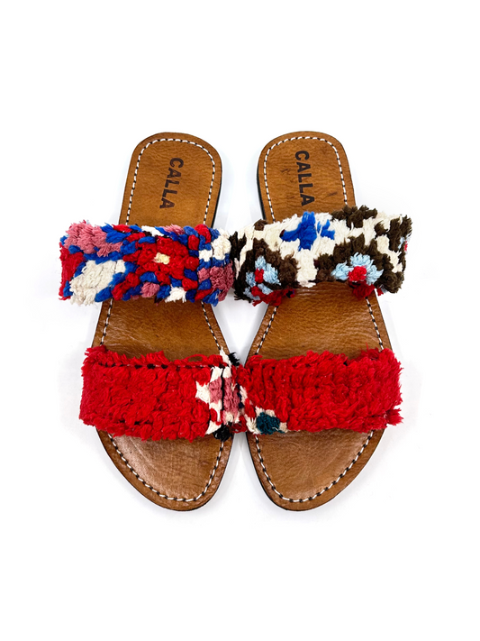 slide sandals with brown leather soles and straps