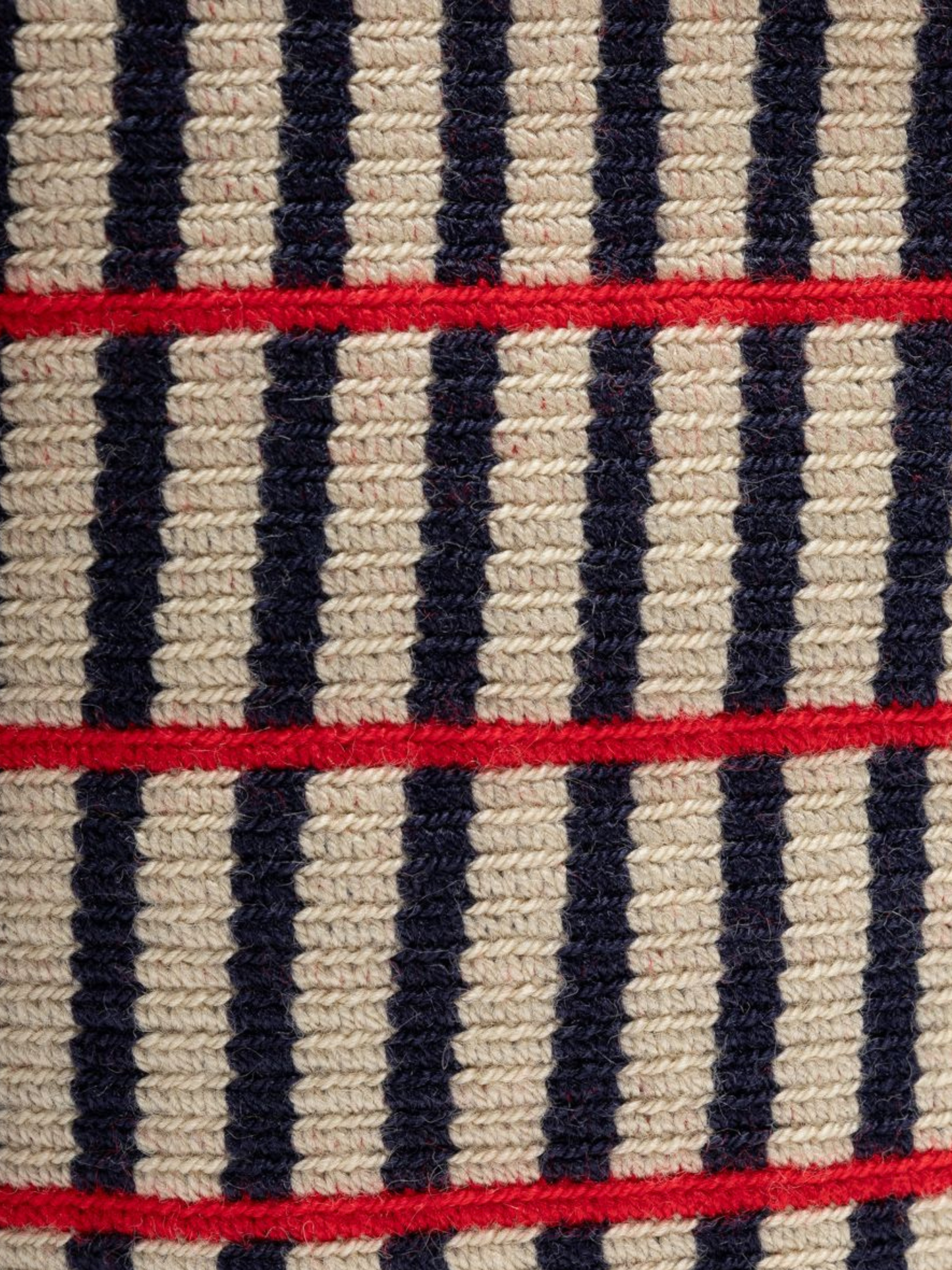 Striped bag with red accents and tassels