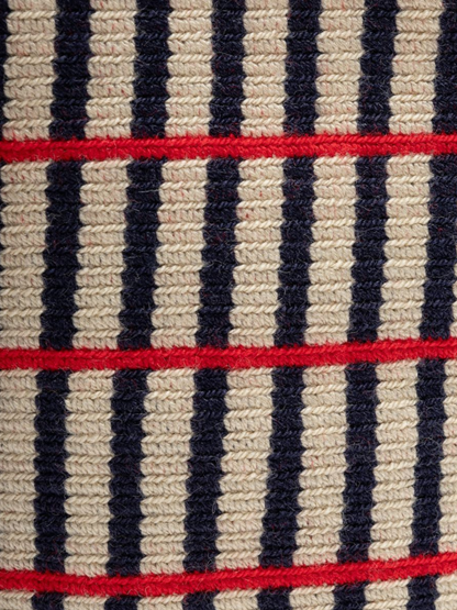 Striped bag with red accents and tassels