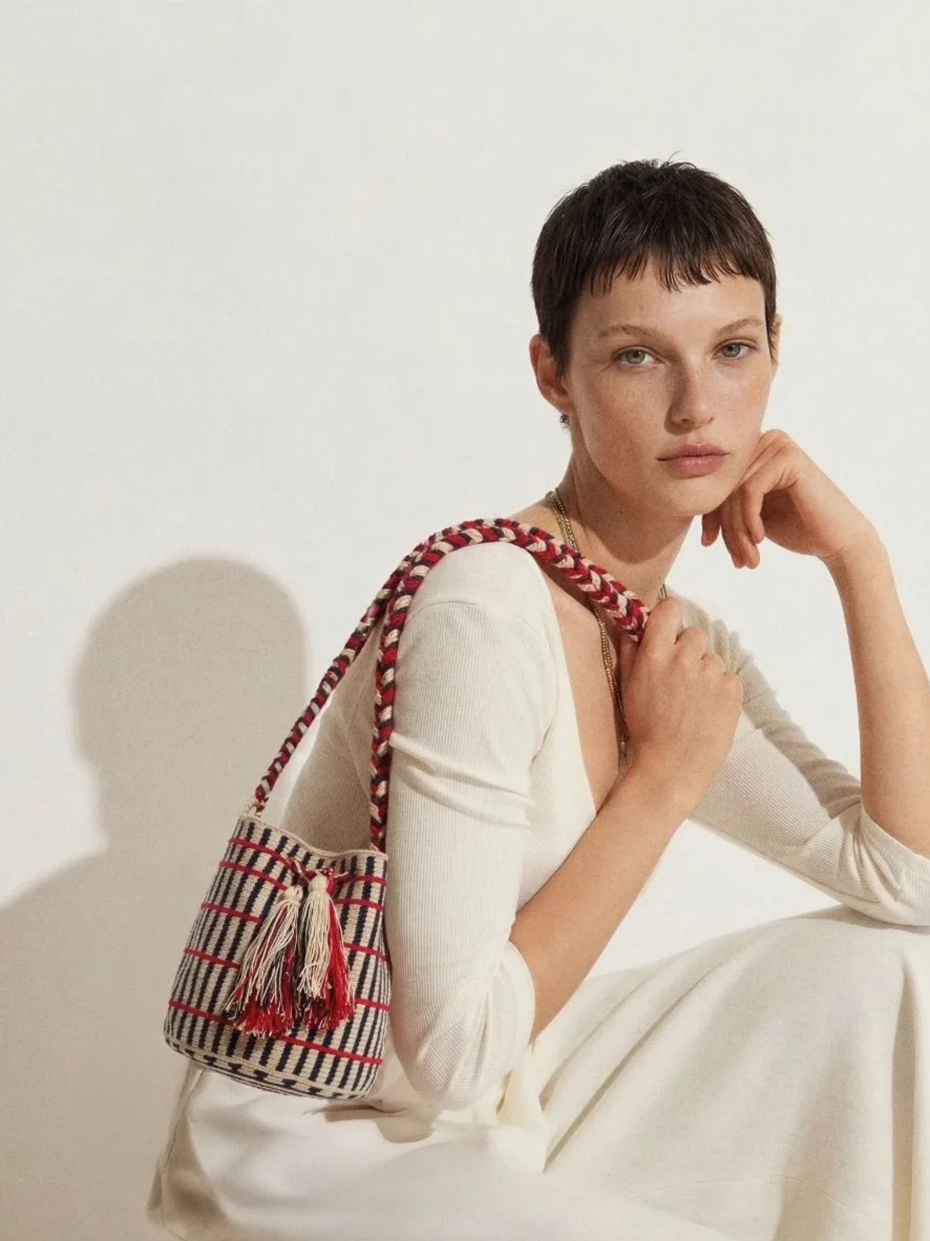 Striped bag with red accents and tassels