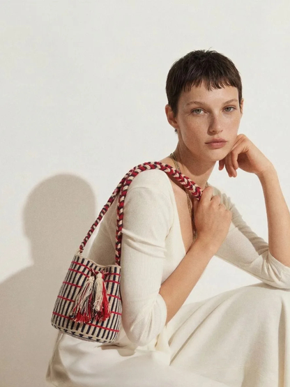 Striped bag with red accents and tassels