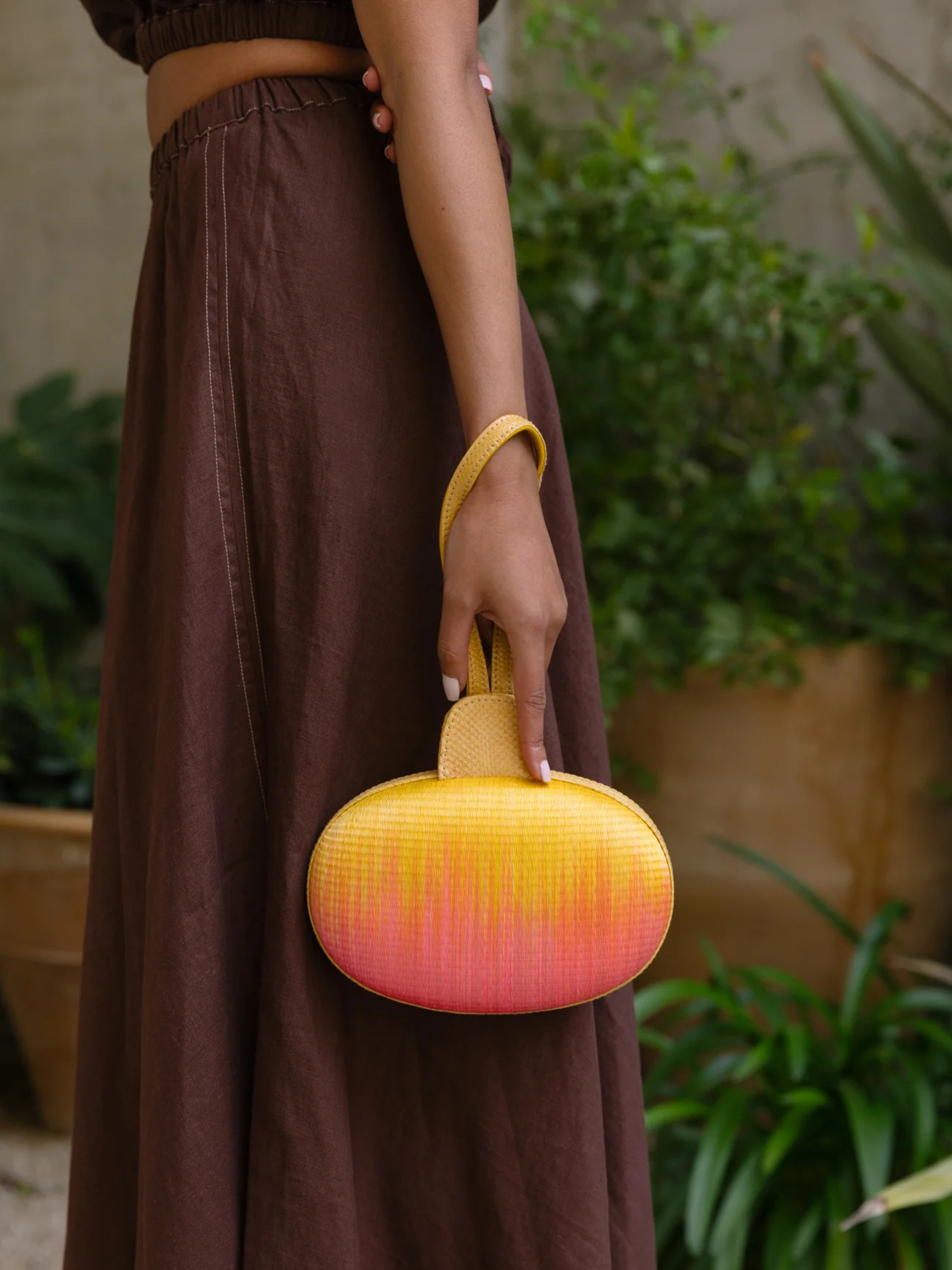 Gradient yellow to pink oval pouch with handle 