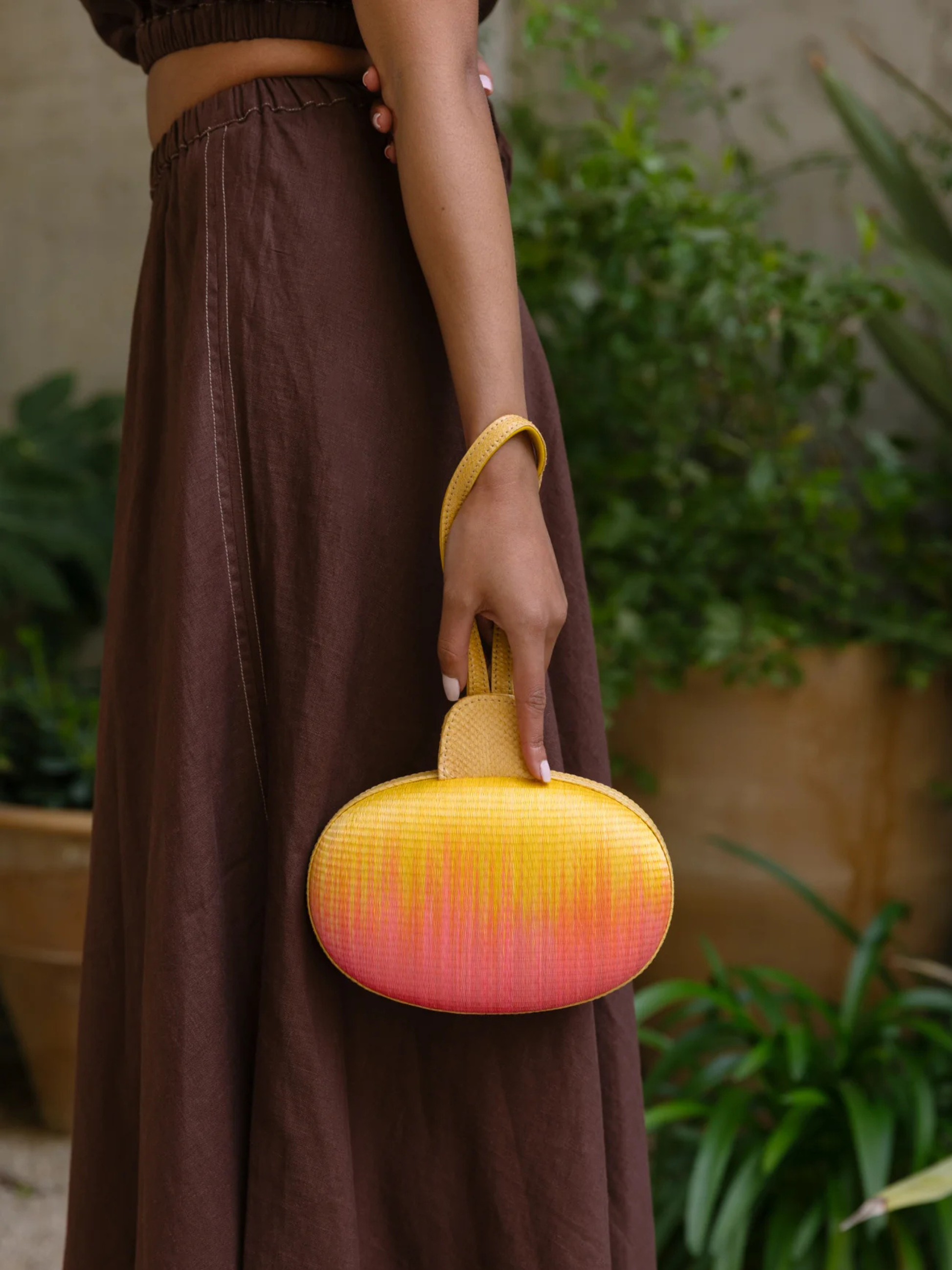 Gradient yellow to pink oval pouch with handle 