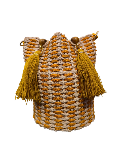 Handwoven iraca bucket bag with sculptural shape and vibrant weave. 