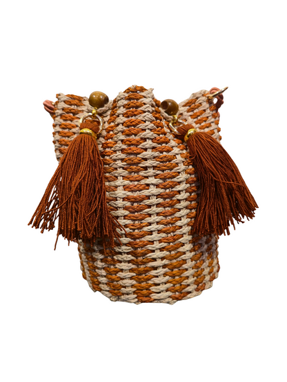 Handwoven iraca bucket bag with sculptural shape and vibrant weave. 