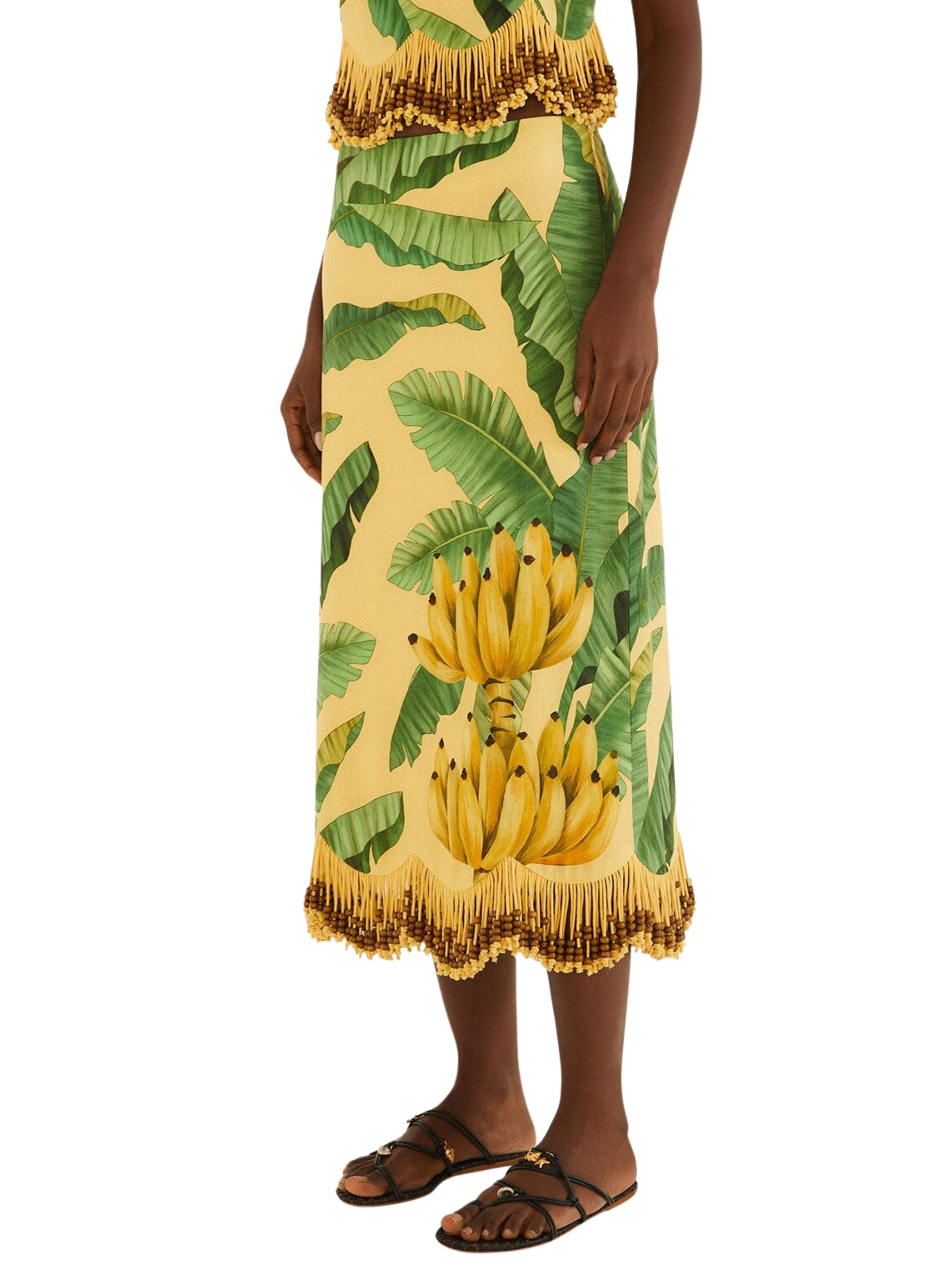 yellow midi skirt with a green banana and palm leaf print, featuring gold fringe 