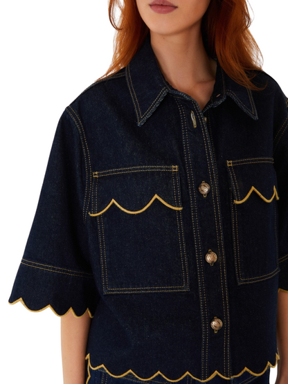 dark indigo denim short-sleeve button-up shirt jacket with yellow contrast stitching and scalloped edges