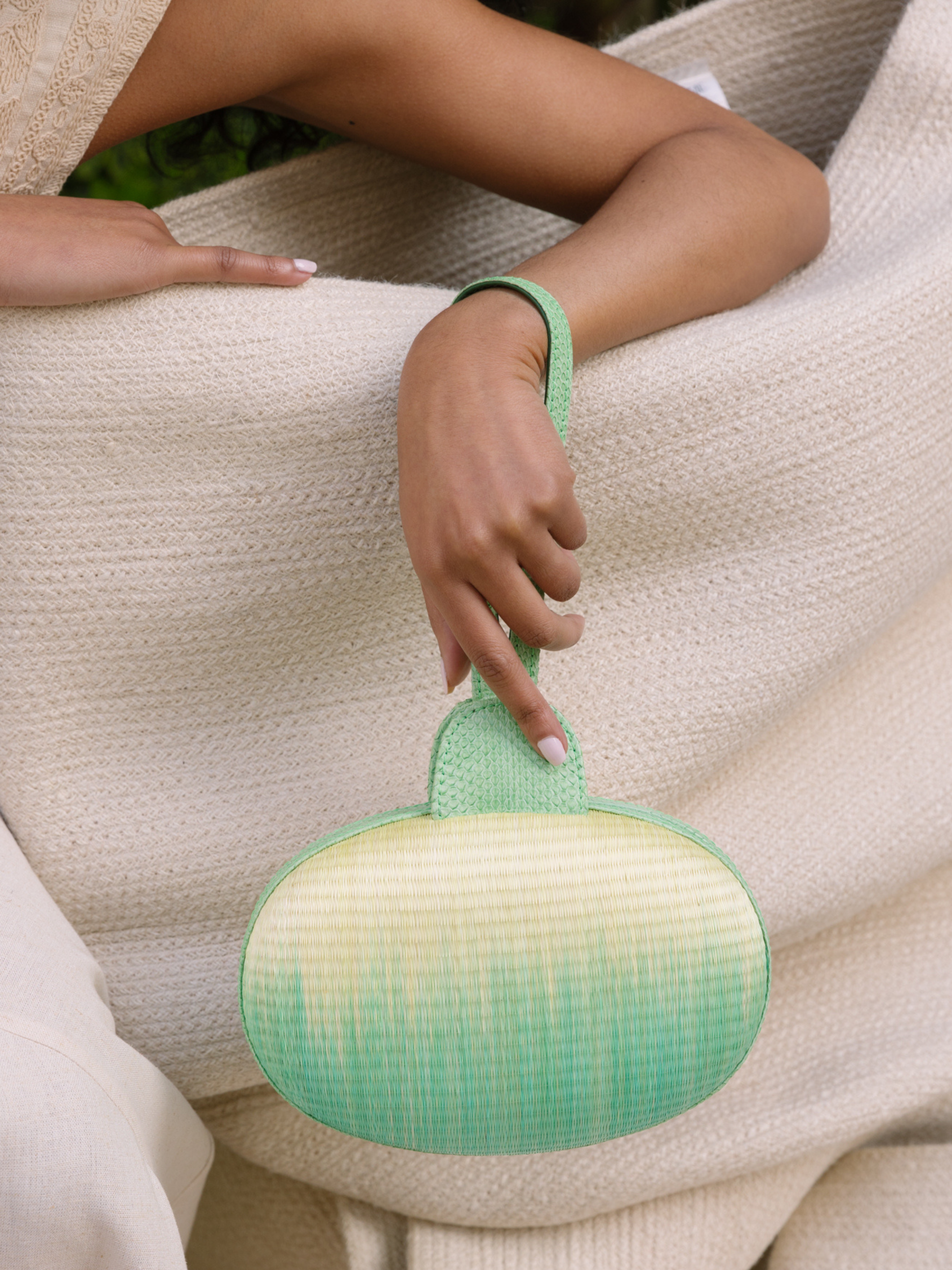 Green and yellow oval-shaped pouch with a strap