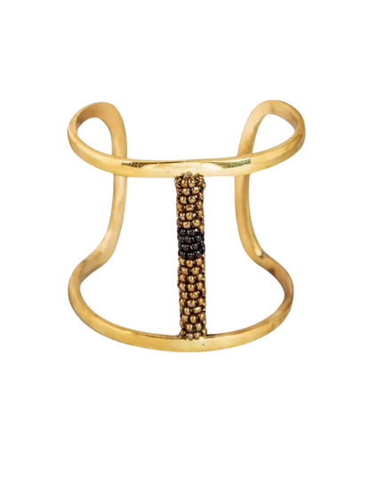 gold-toned open cuff bracelet featuring a central vertical column of small metallic beads in gold and black