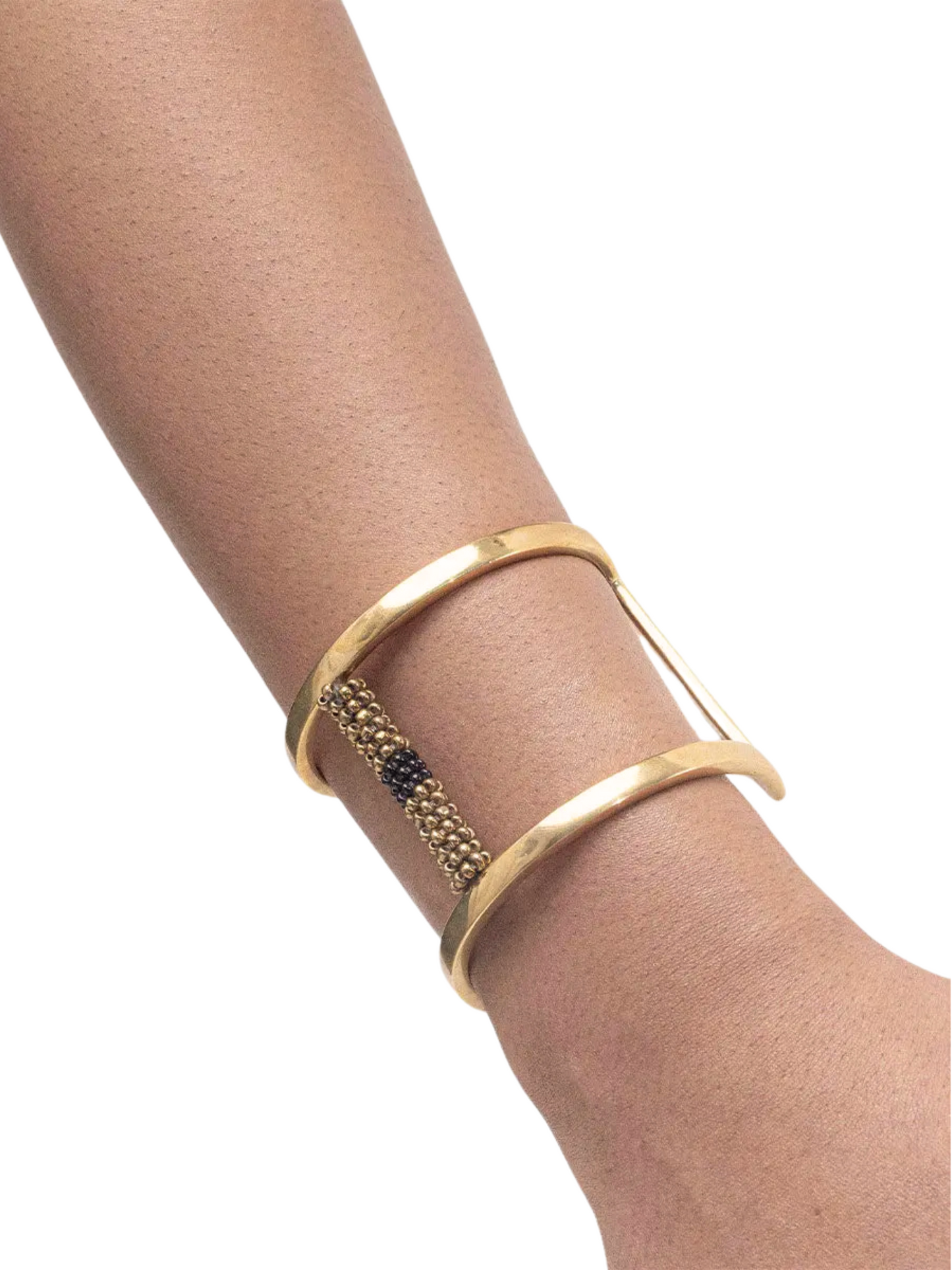 gold-toned open cuff bracelet featuring a central vertical column of small metallic beads in gold and black