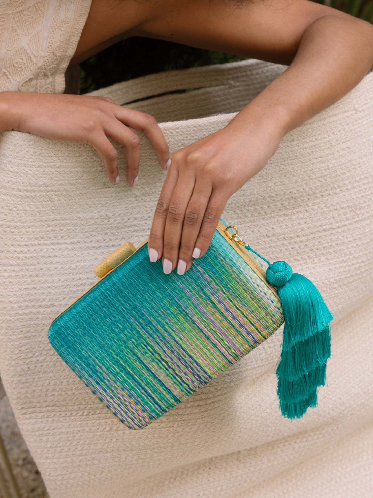 green textured clutch with tassels 