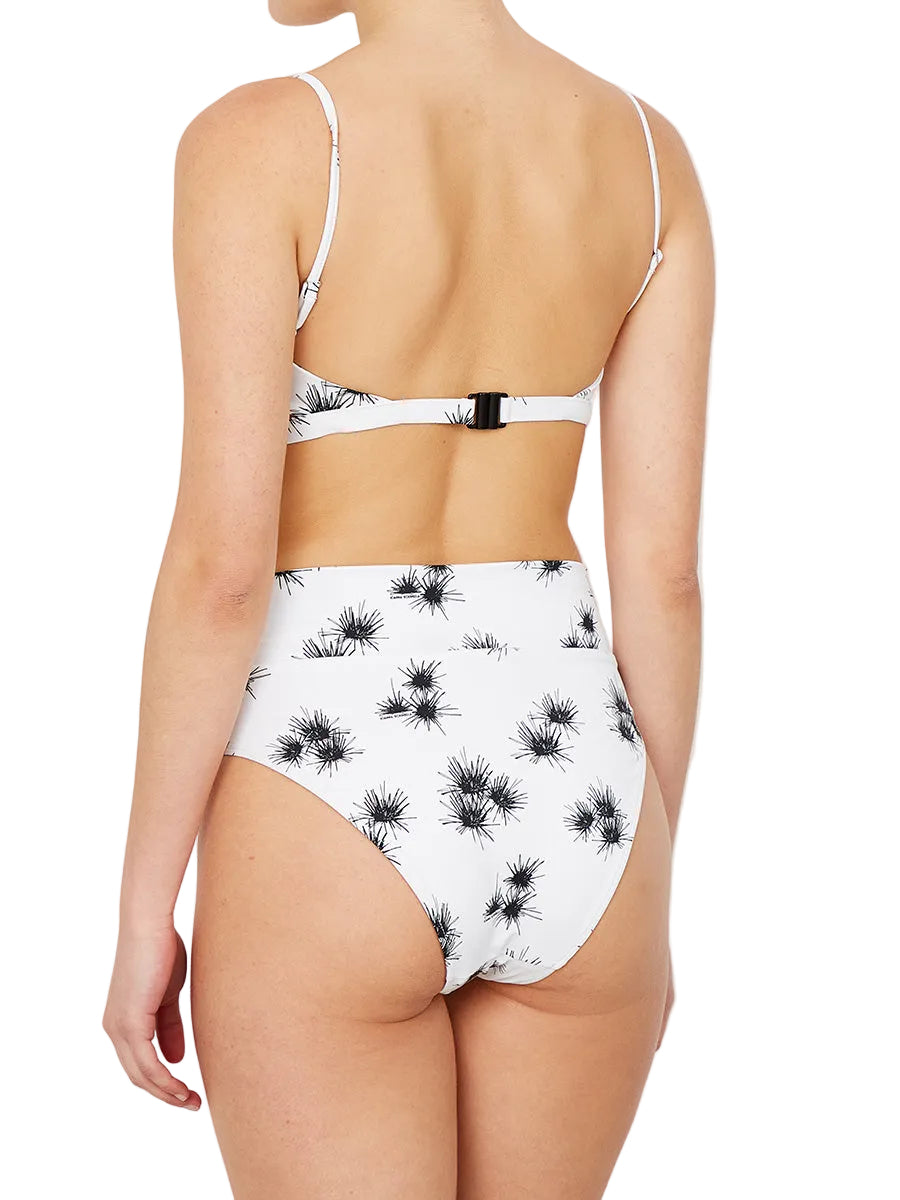 white bikini with a floral print , featuring adjustable straps and a clasp at the back